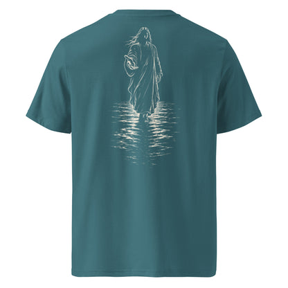 A teal blue short-sleeve t-shirt shown from the back, featuring a white line art graphic of a robed figure standing in water with reflections.