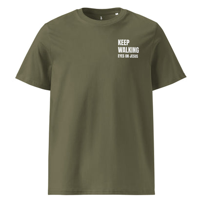 An olive green crewneck t-shirt with white printed text on the left chest reading 'KEEP WALKING EYES ON JESUS', displayed on a solid white background.
