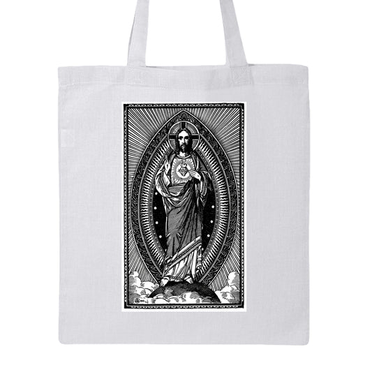 A white canvas tote bag with a large black-and-white graphic print of the Sacred Heart of Jesus on the front, shown against a plain white background.