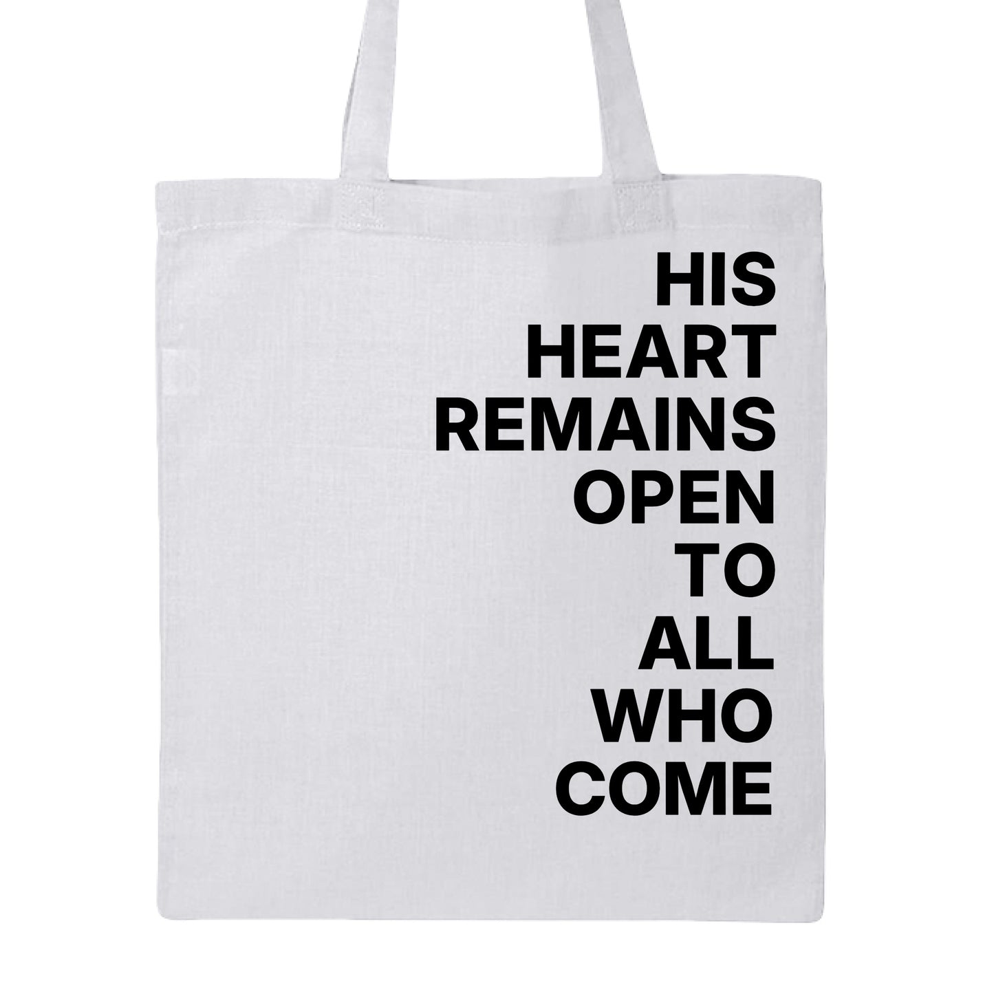 A white canvas tote bag with black printed text reading 'HIS HEART REMAINS OPEN TO ALL WHO COME' on a plain white background.